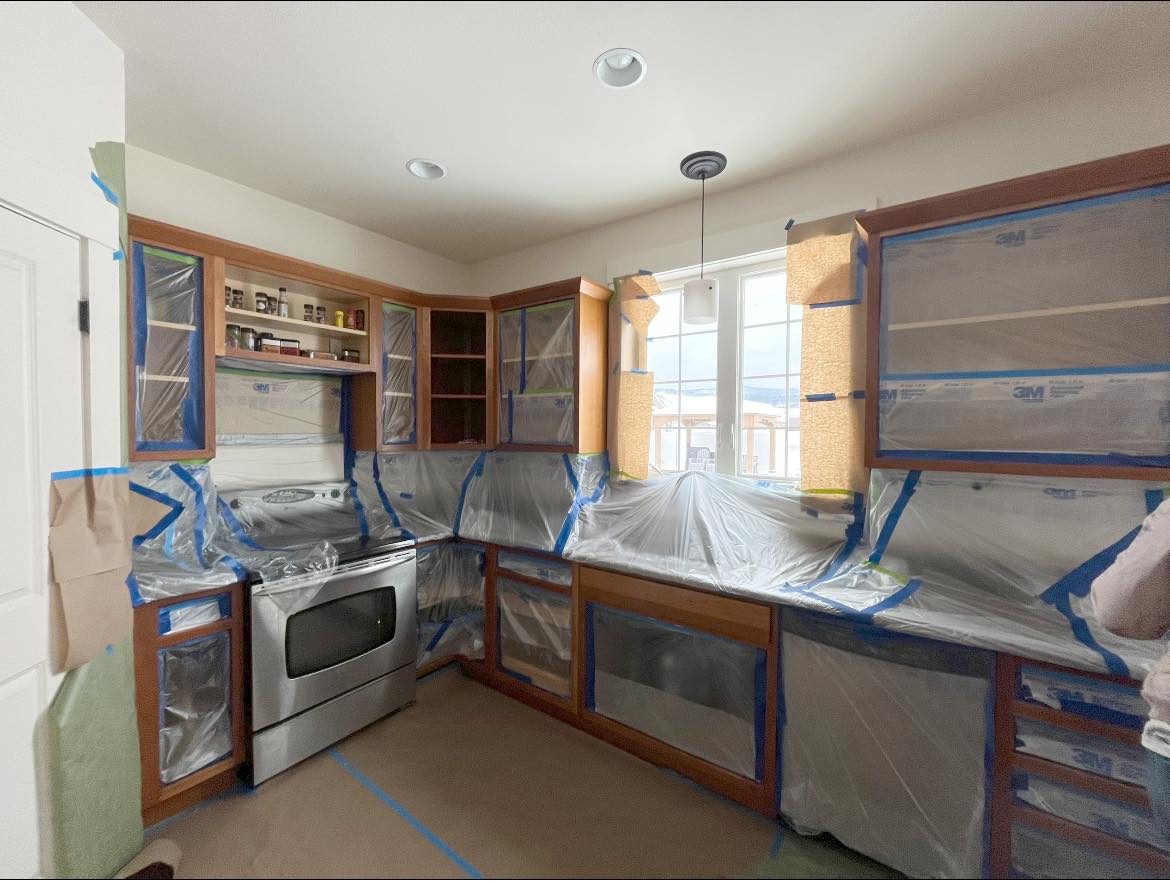 Kitchen cabinets fully masked and prepped for spraying by Treeline Painting