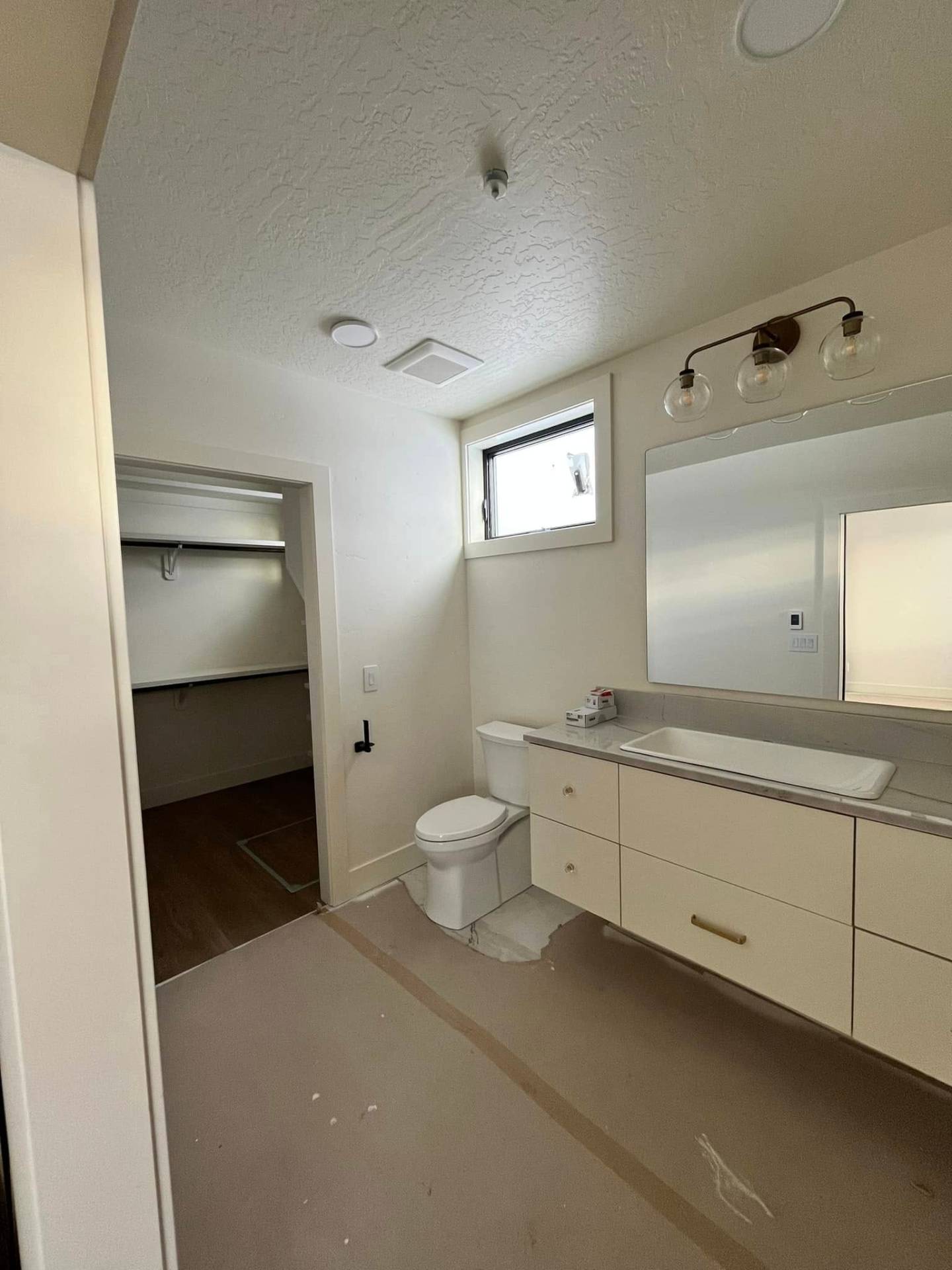 Bathroom before paint with bare floors and unfinished walls by Treeline Painting