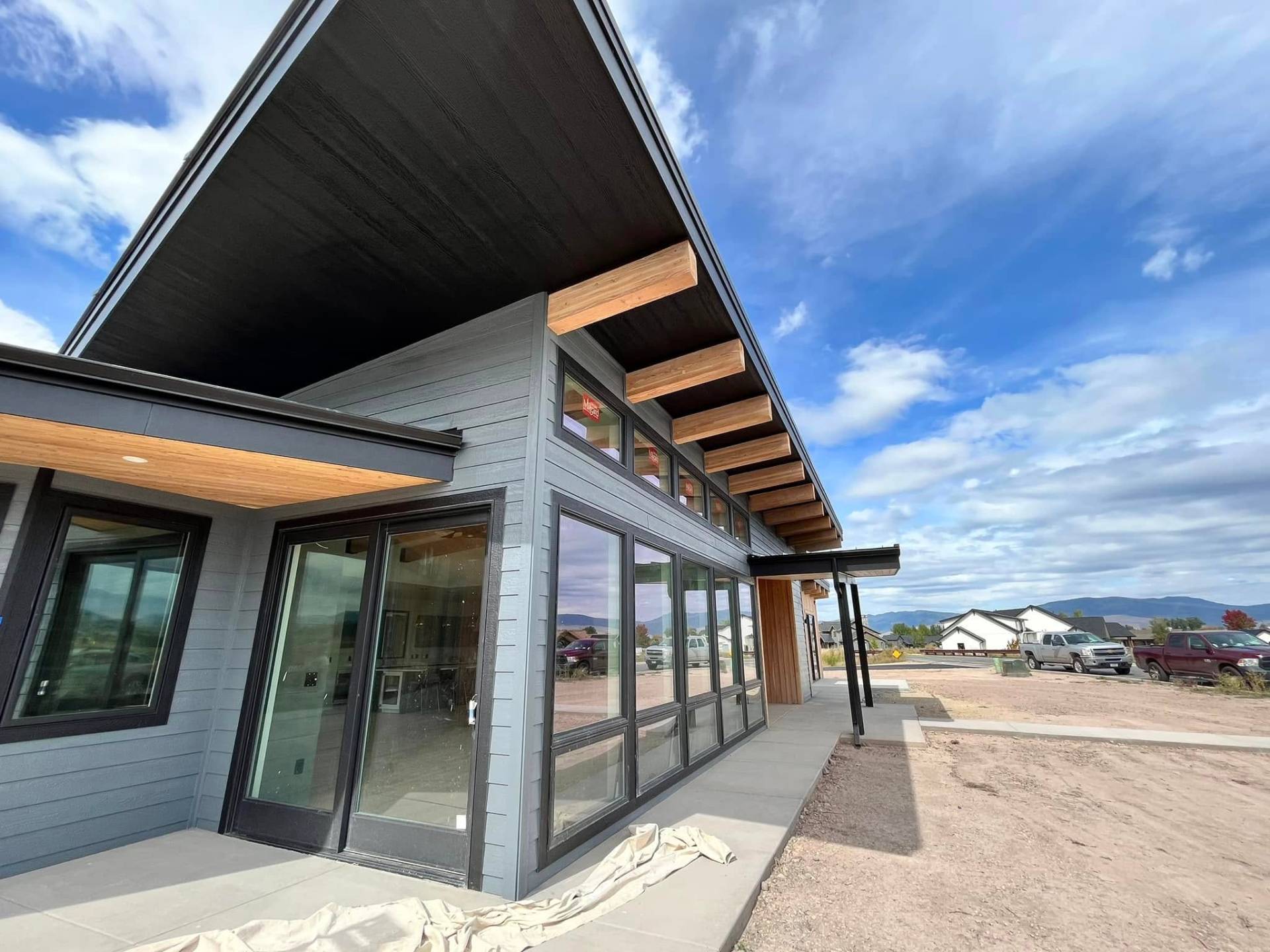 Contemporary home exterior with floor-to-ceiling windows painted by Treeline Painting