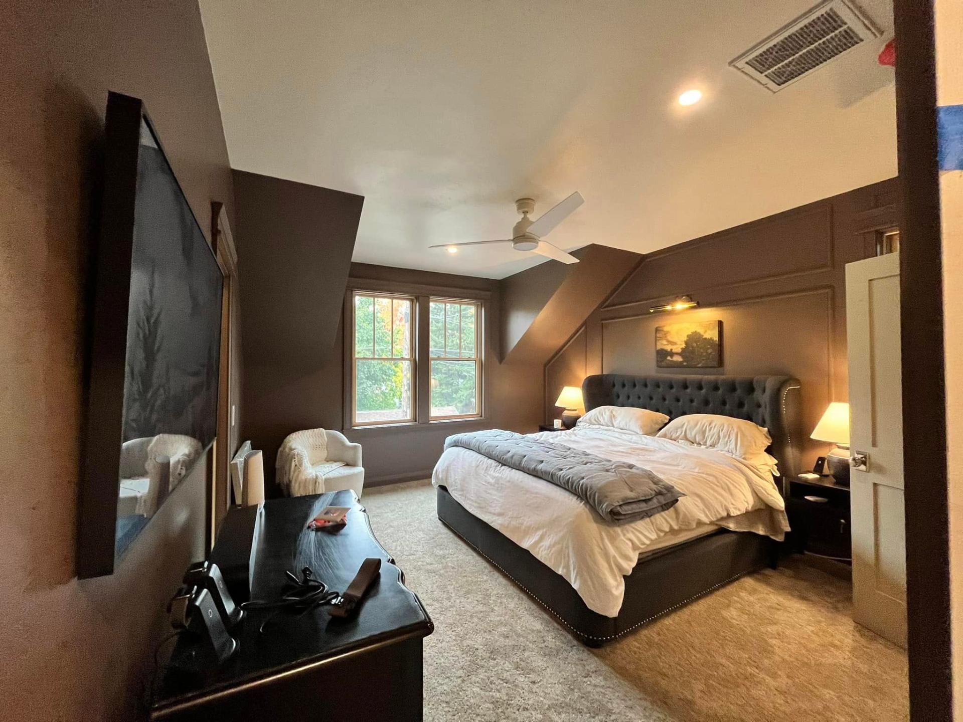Warm taupe bedroom with paneled accent wall painted by Treeline Painting