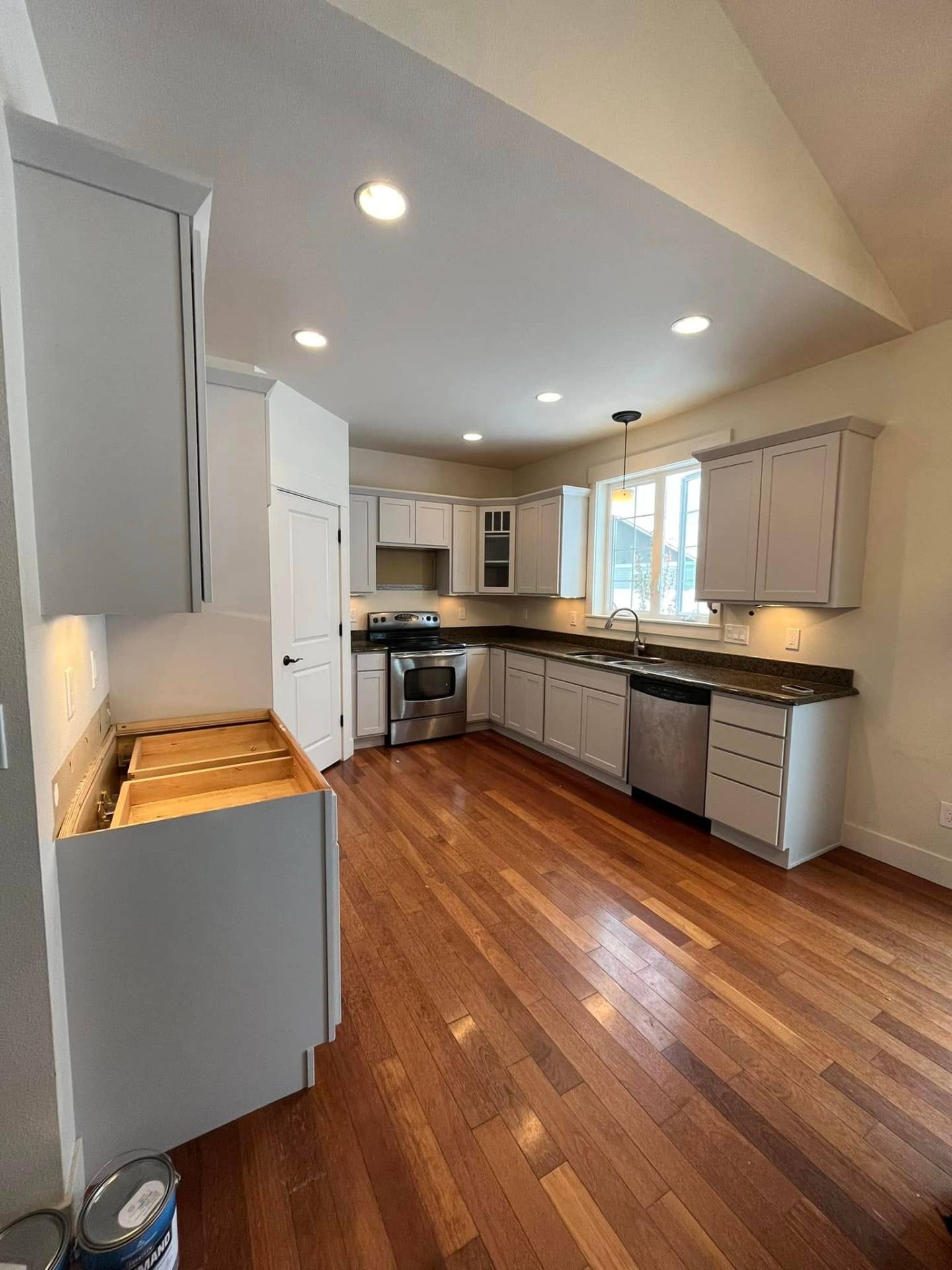 Light gray sprayed kitchen cabinets after professional prep