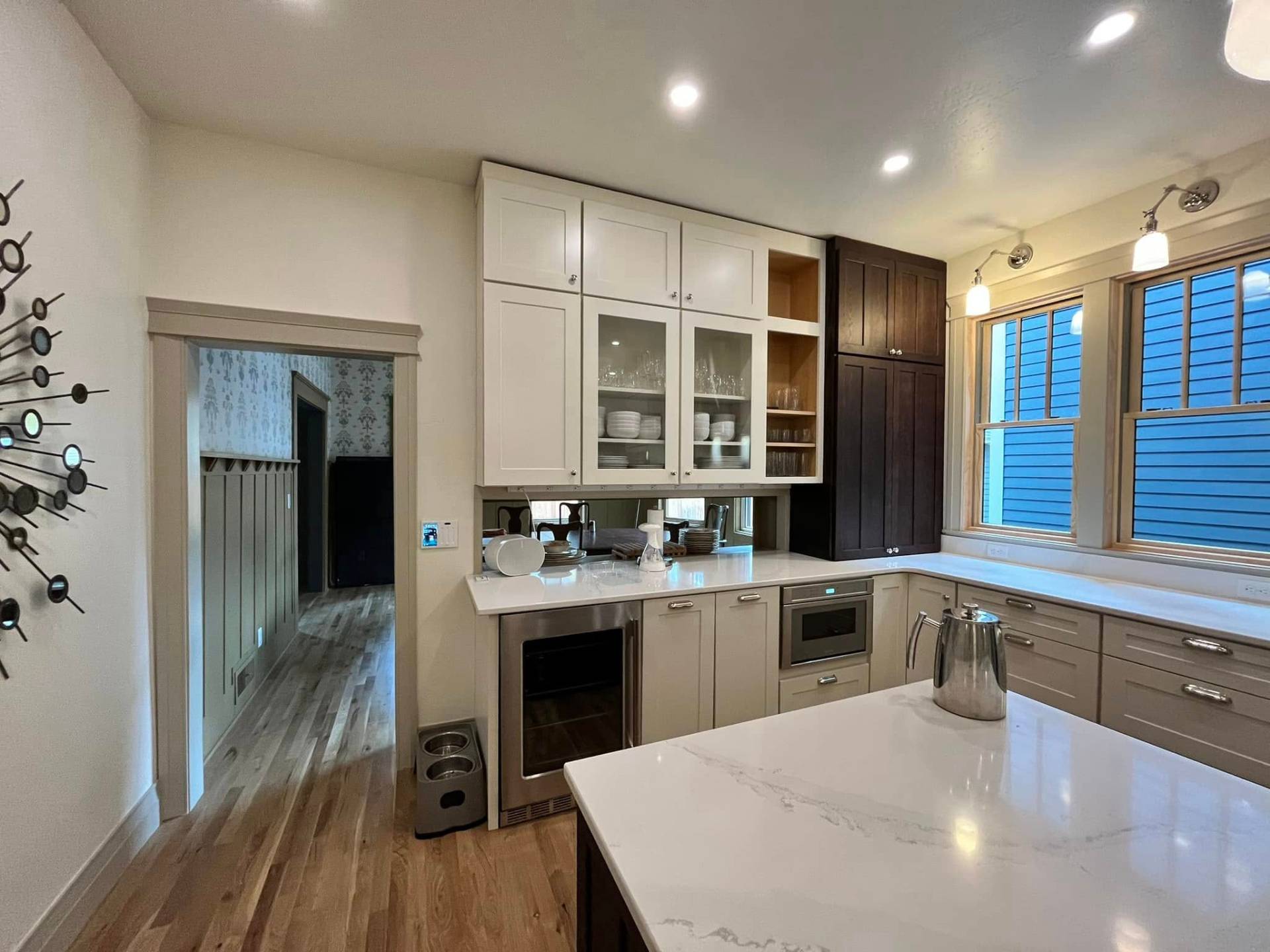 Two-tone kitchen with white and walnut cabinets painted by Treeline Painting