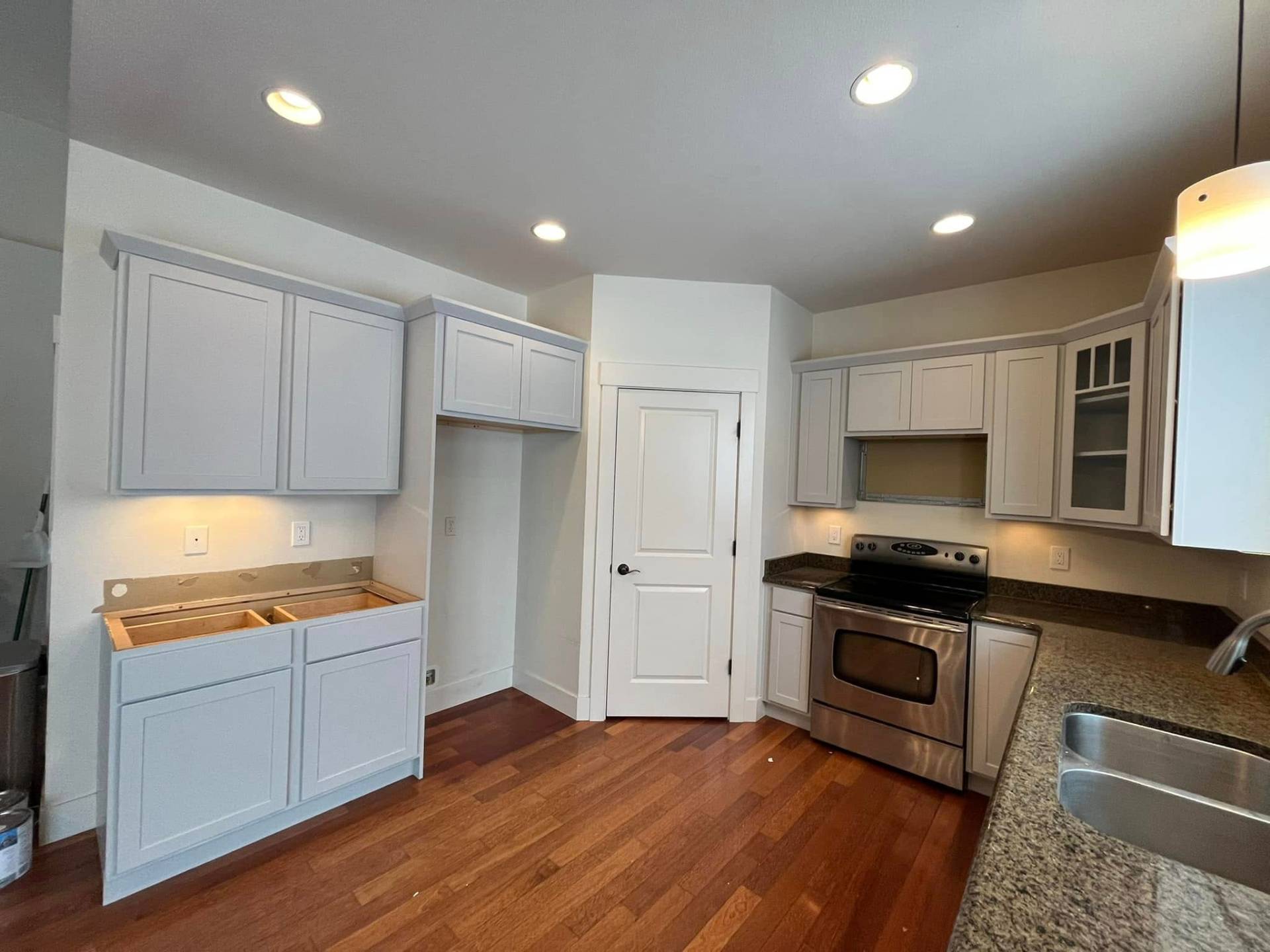 Detailed view of freshly painted gray kitchen cabinets by Treeline Painting