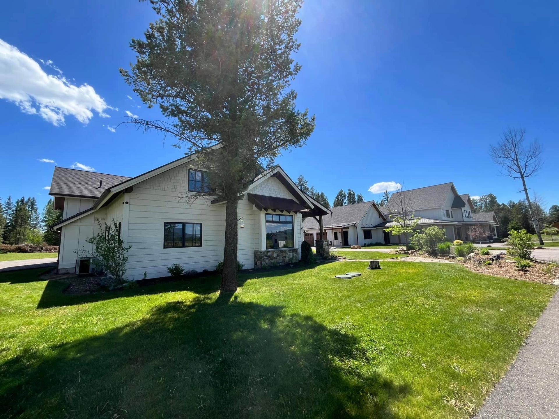 White farmhouse exterior painted by Treeline Painting in Western Montana