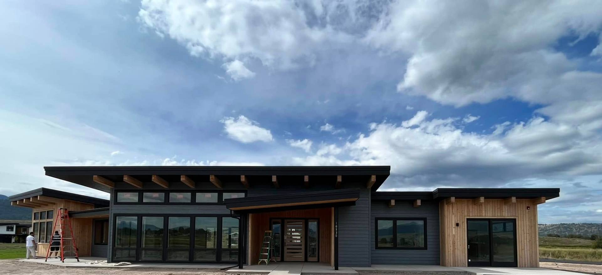 Modern contemporary home with dark siding and cedar accents
