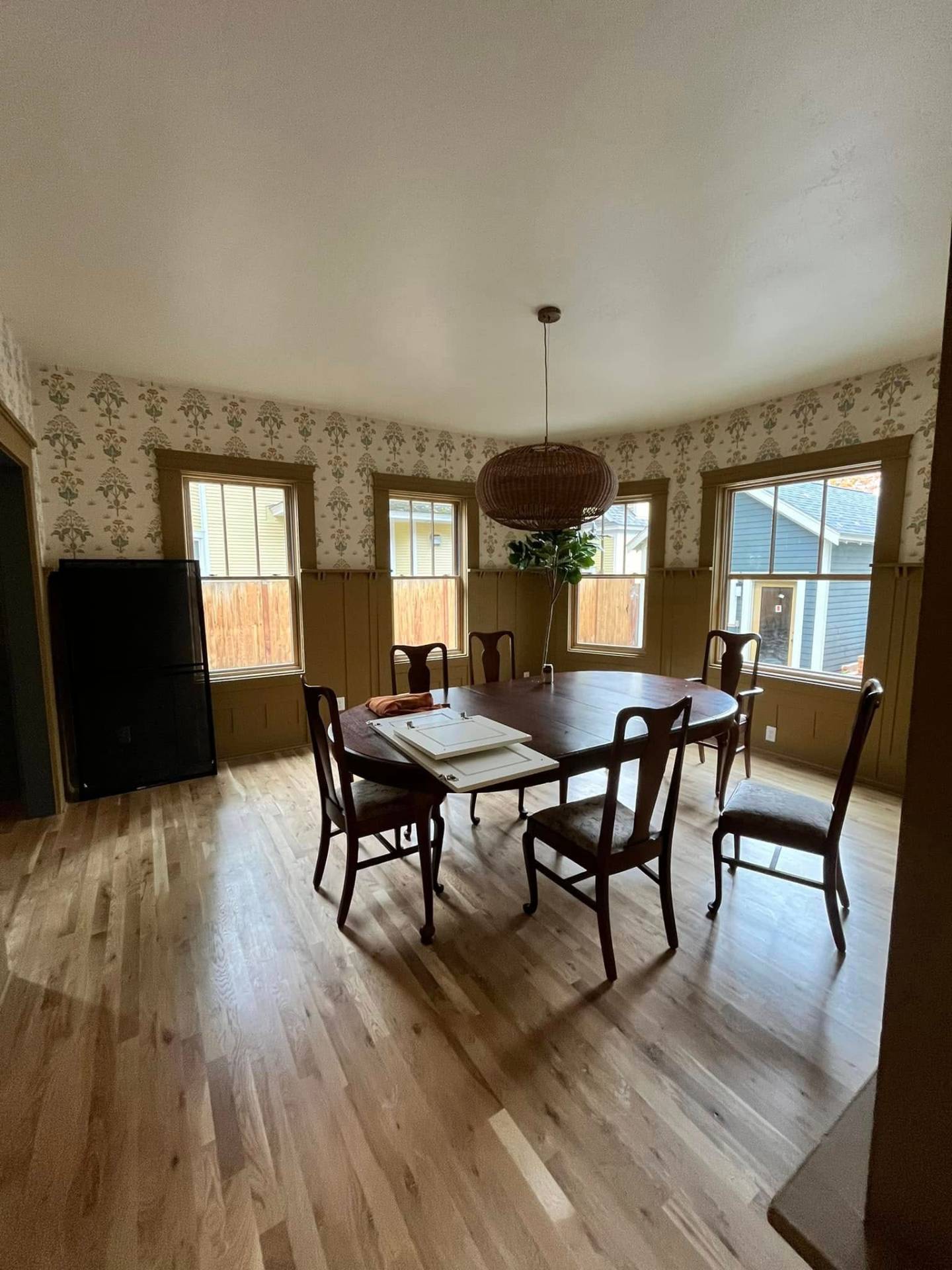 Dining room with olive wainscoting and floral wallpaper painted by Treeline Painting