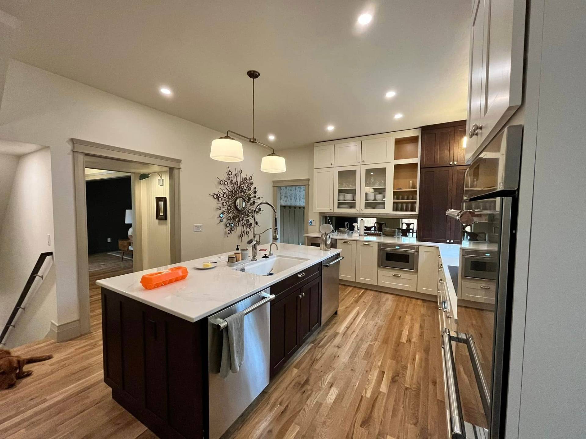 Kitchen island with espresso base and white perimeter cabinets painted by Treeline Painting